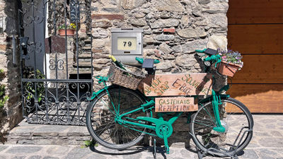 A colorful bike doubling as a storefront sign creates a scenic moment captured in Austria's Wachau Valley.