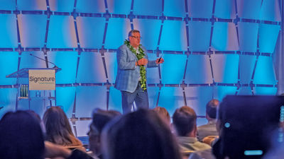 Signature president and CEO Alex Sharpe on stage at the 2023 Owner's Meeting at the Grand Wailea.